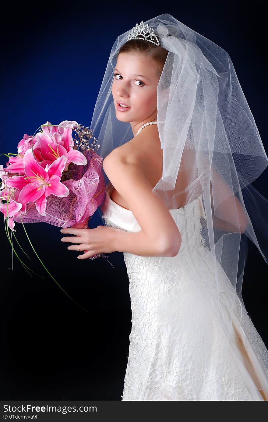 Young bride with bouquet of lilys on a black background