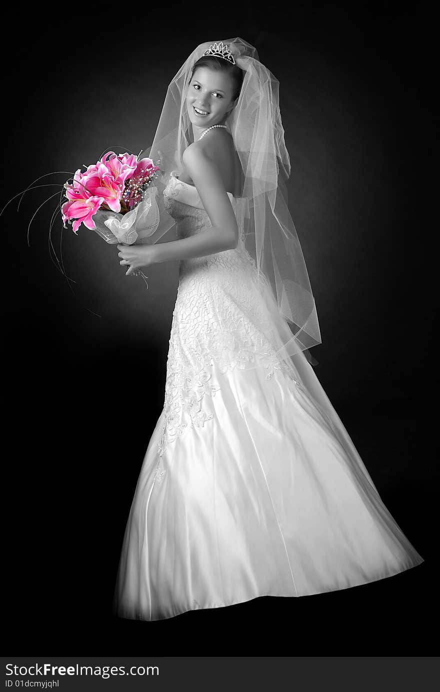 Young bride with bouquet of lilys on a black background