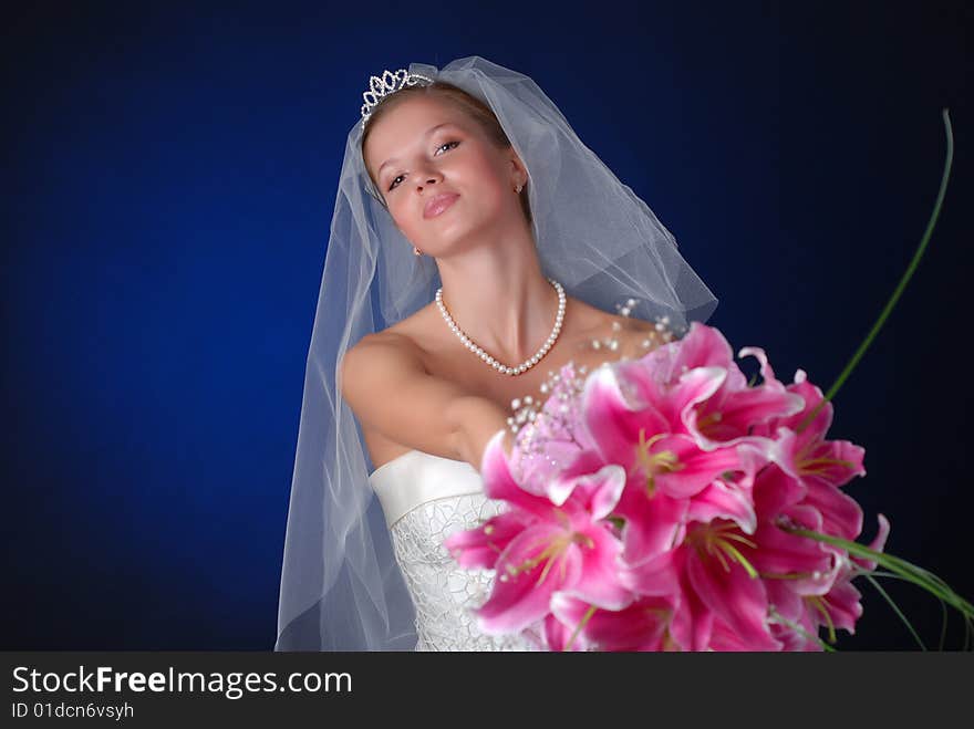 Young bride with bouquet of lilys on a black background