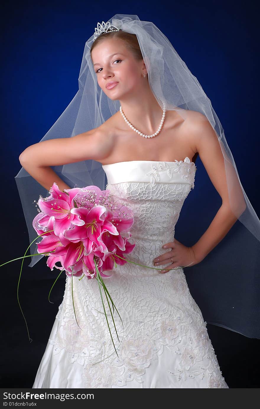 Young bride with bouquet of lilys on a black background