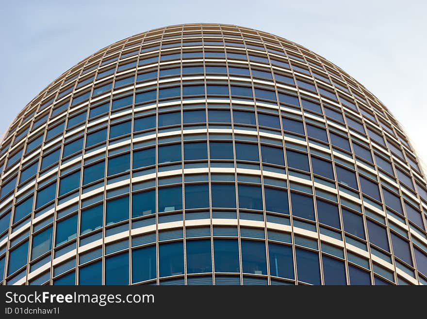 Fragment of a high modern building with many windows. View from the bottom. Fragment of a high modern building with many windows. View from the bottom.