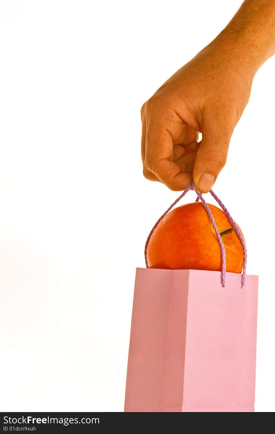 A red apple in a lunchbag on white background