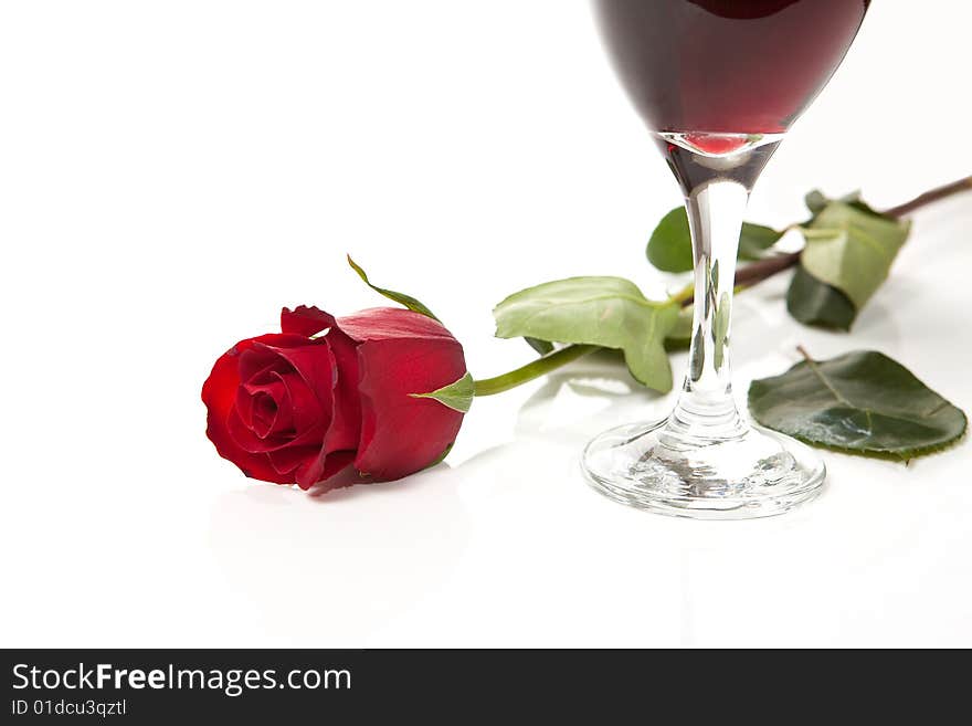 Red Rose On White Background With Glass Of Wine