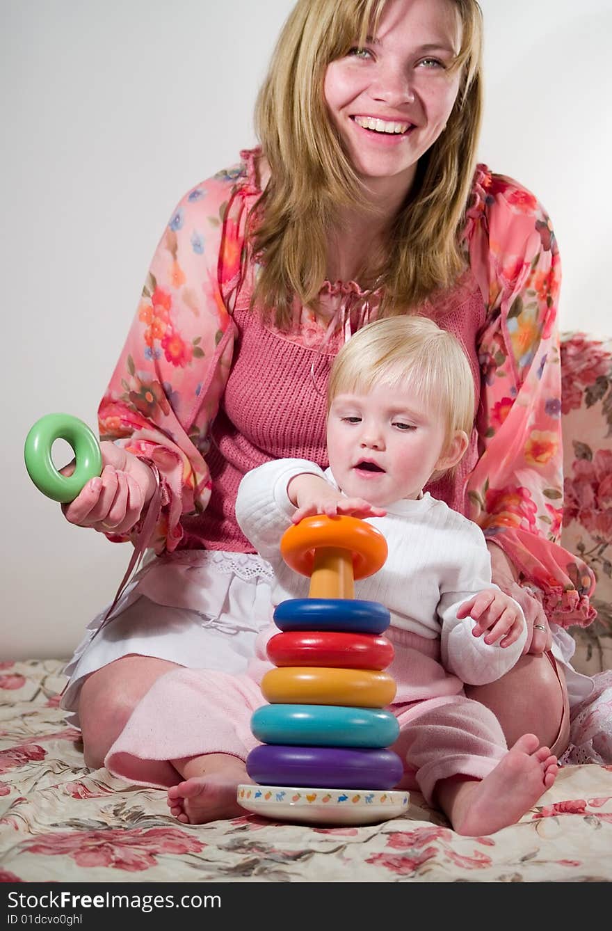 Child builds pyramid with mother