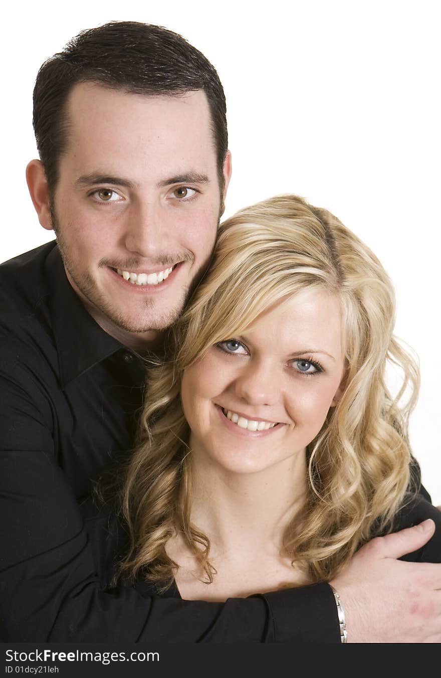 Attractive couple wearing black shirts against a white background. Attractive couple wearing black shirts against a white background.