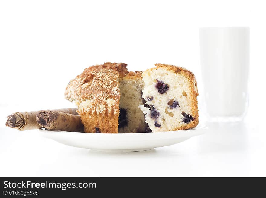 Freshly baked sliced muffin white glass of milk