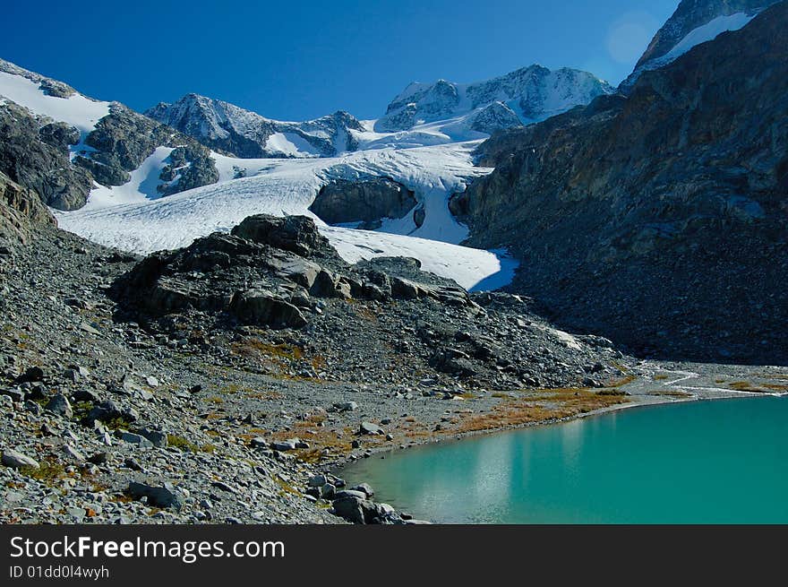 Glacier lake in the mountain in the early fall