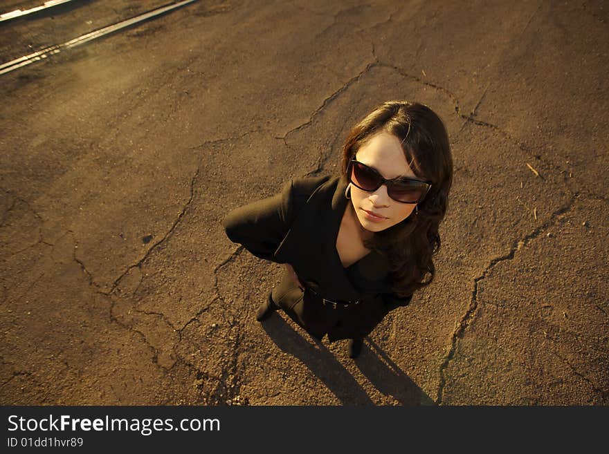 Beautiful woman in black trenchcoat in an urban setting. Beautiful woman in black trenchcoat in an urban setting