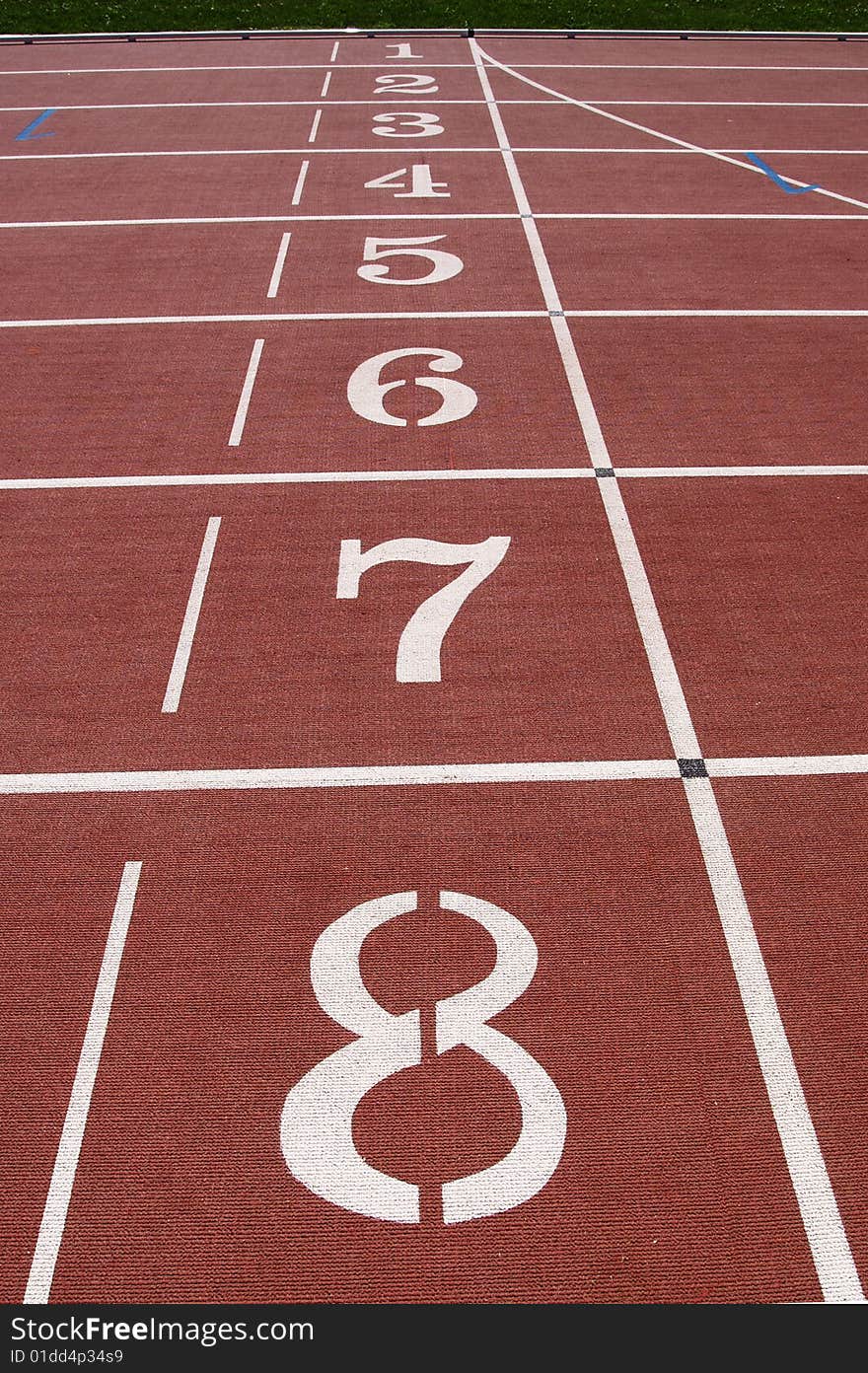 Numbered 8 to 1, vertical, at the starting position on running track. Numbered 8 to 1, vertical, at the starting position on running track