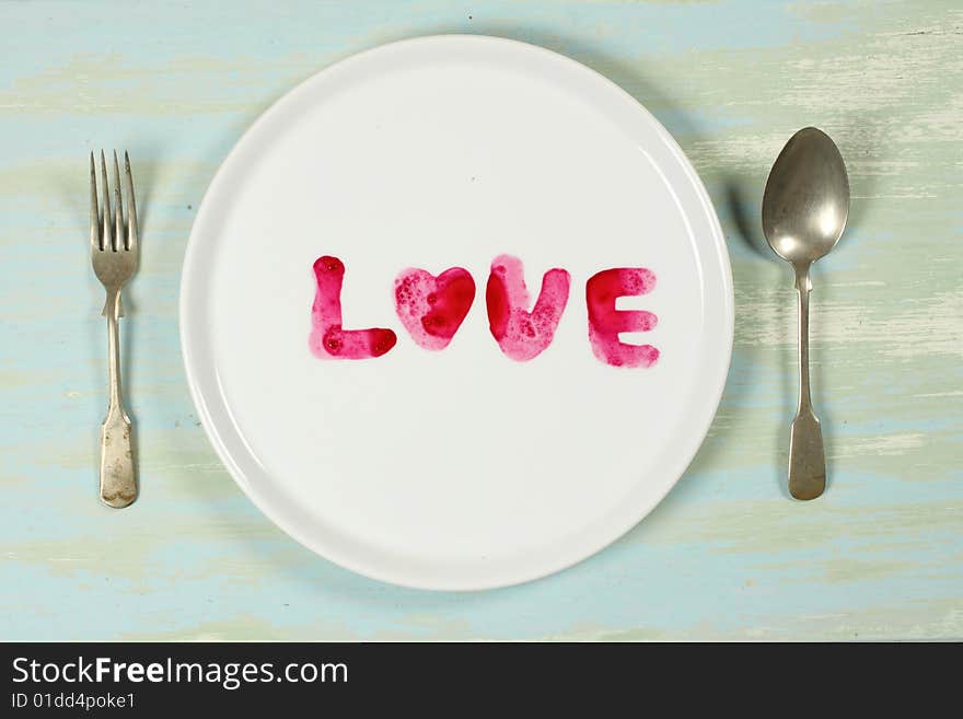 Red color of beet root is written on a plate as love, like ready to eat. Red color of beet root is written on a plate as love, like ready to eat.