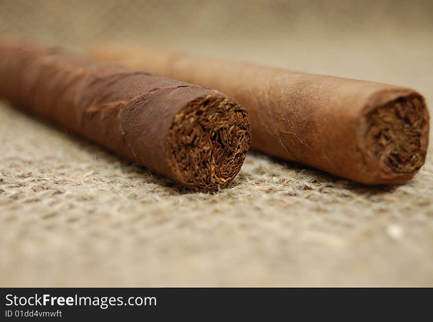 Two cuban cigars on hessian canvas