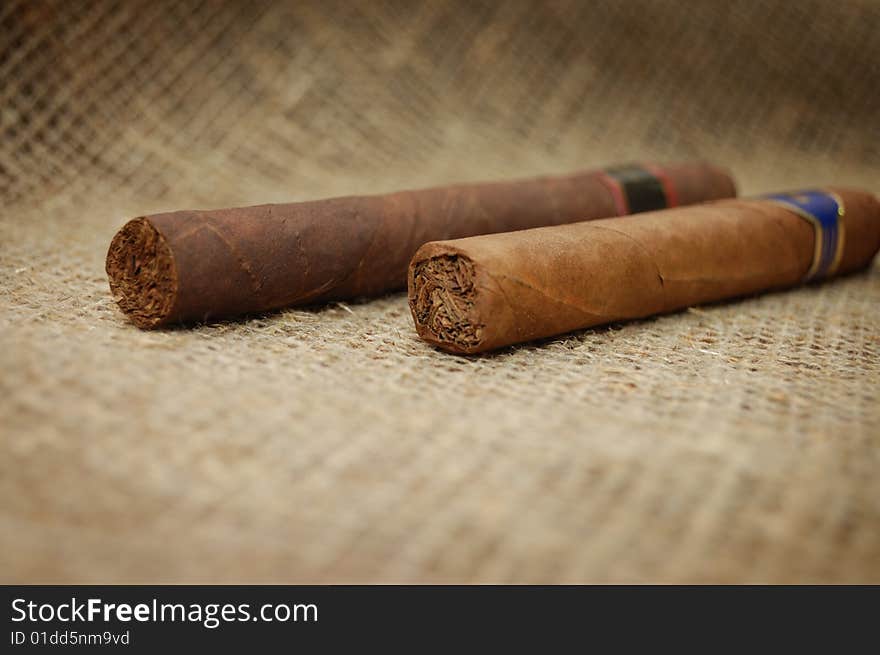 Two cuban cigars on hessian canvas