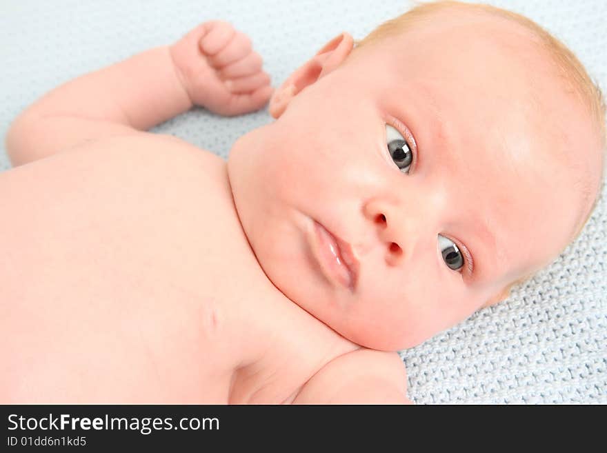 Month old baby boy on a light blue blanket