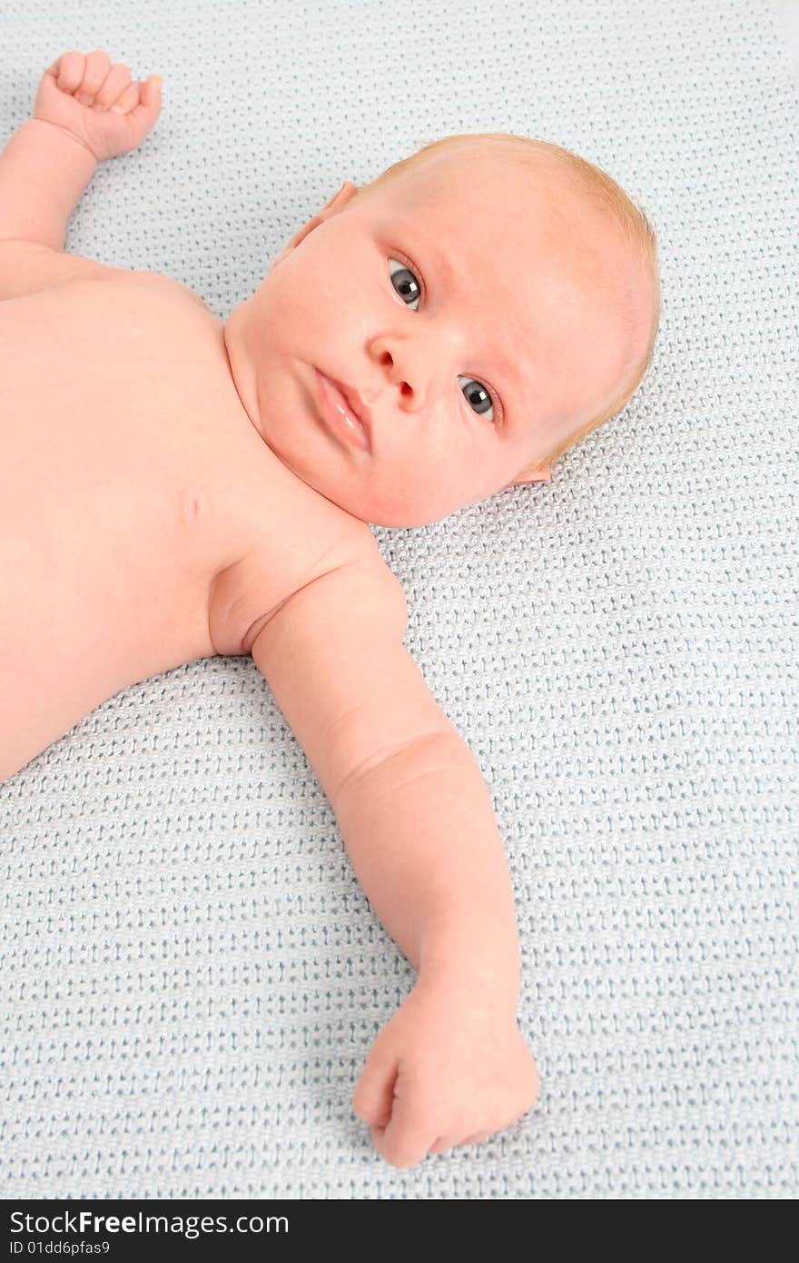 Month old baby boy on a light blue blanket