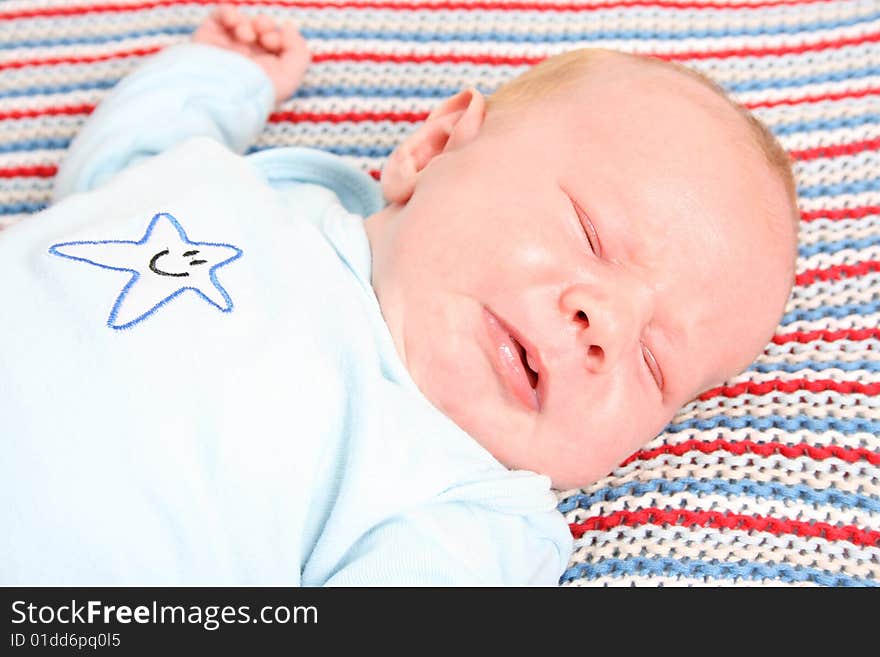 Month old baby boy on a colorful blanket