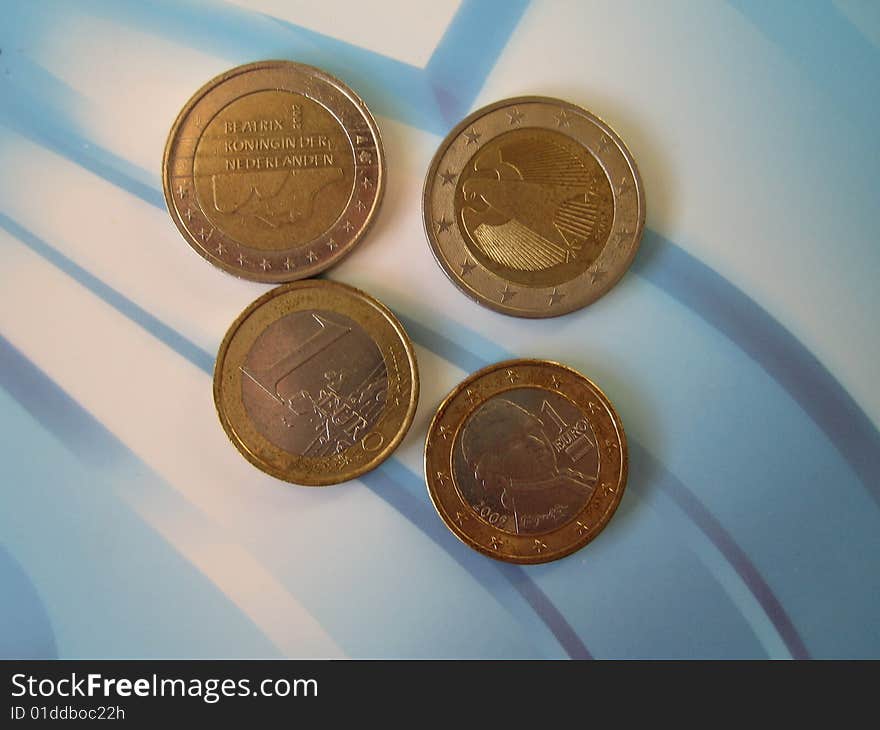 Four coins on abstract background