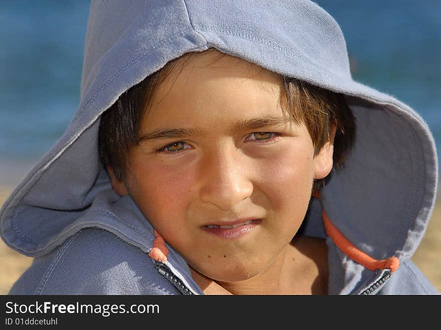 Boy with hooded shirt posing