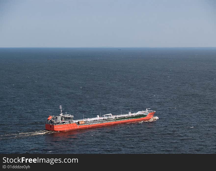 Cargo ship, floating on the sea.