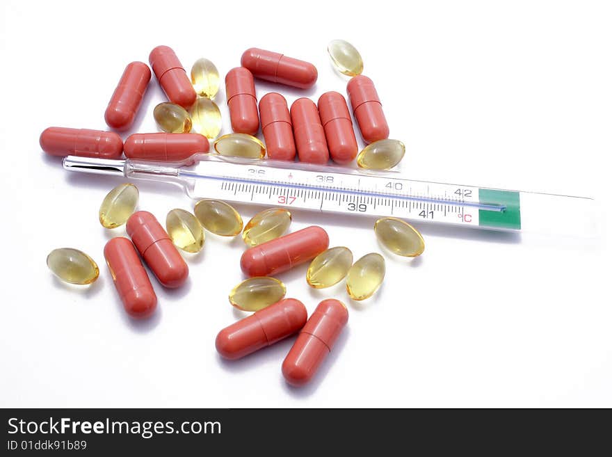 Yellow and brown pills with thermometer