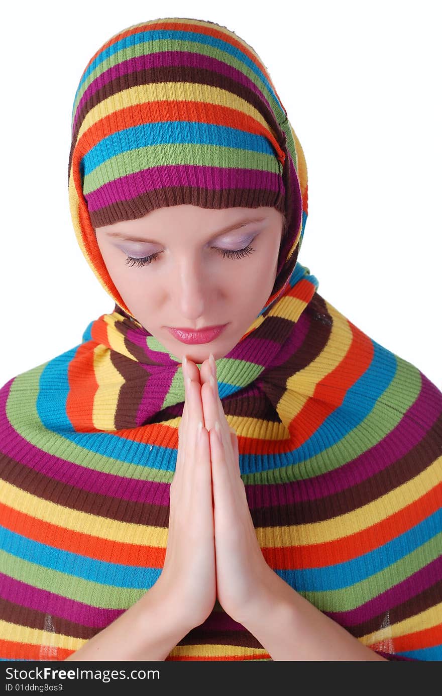 Young beautiful woman in a  striped sweater is praying