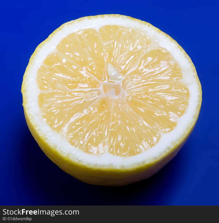 Half of lemon on blue background