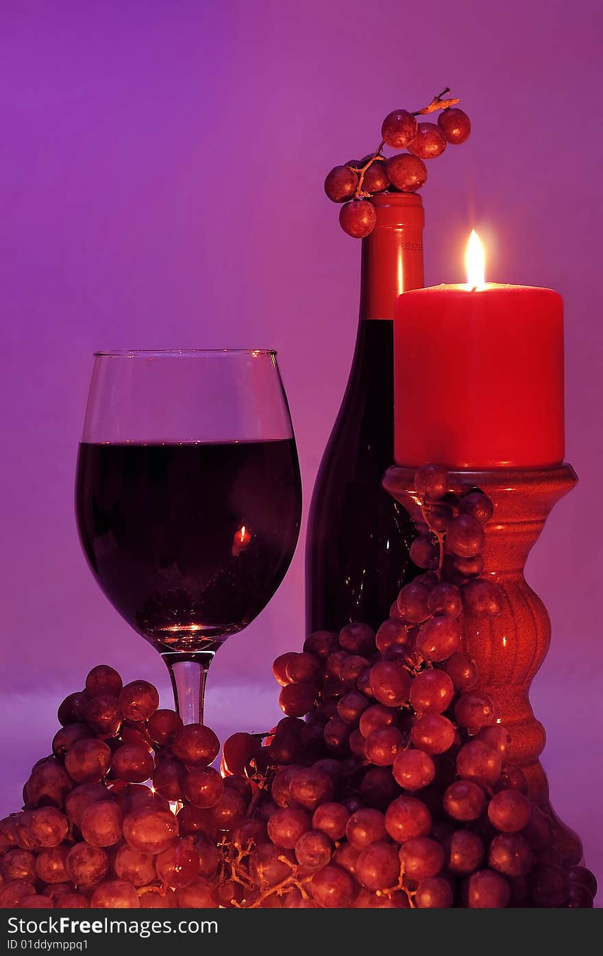 Wine and grapes in candle light. Wine and grapes in candle light