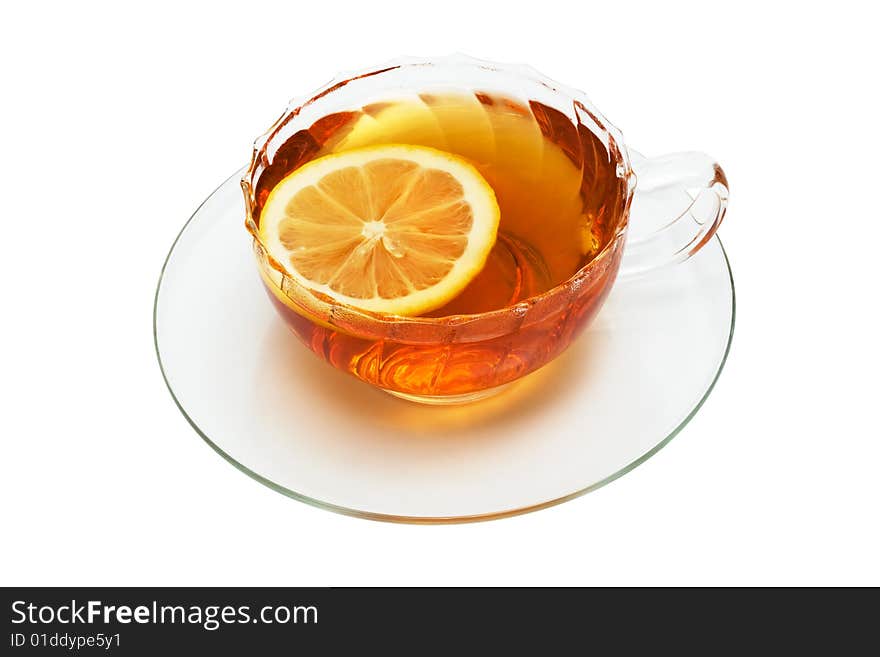 Glass cup with tea and a lemon on a white background