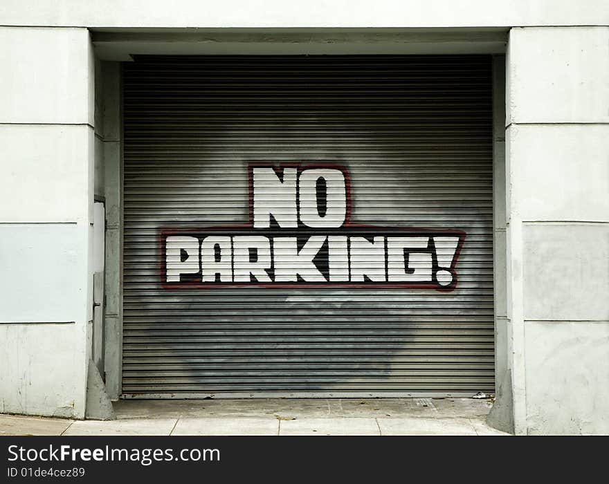 No Parking Sign on Garage Door in Urban Area