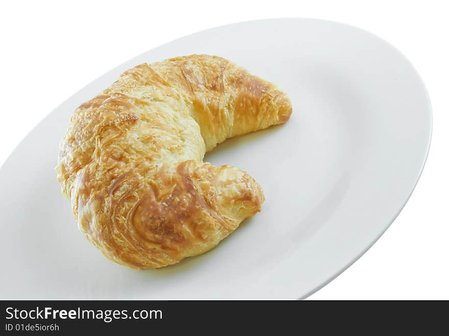 Croissant on plate isolated on white background