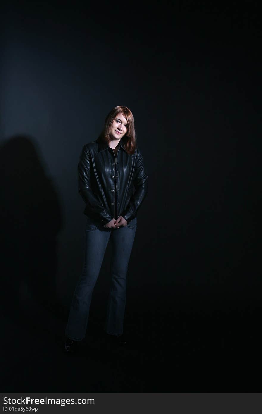 Teenage girl in black leather jacket smiling