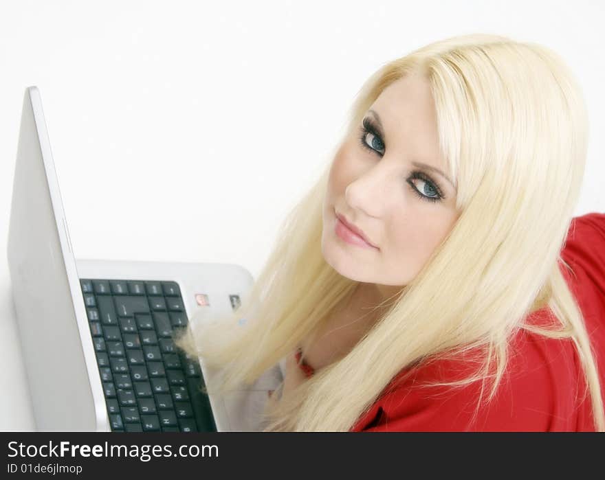 A blond young woman with a laptop. A blond young woman with a laptop