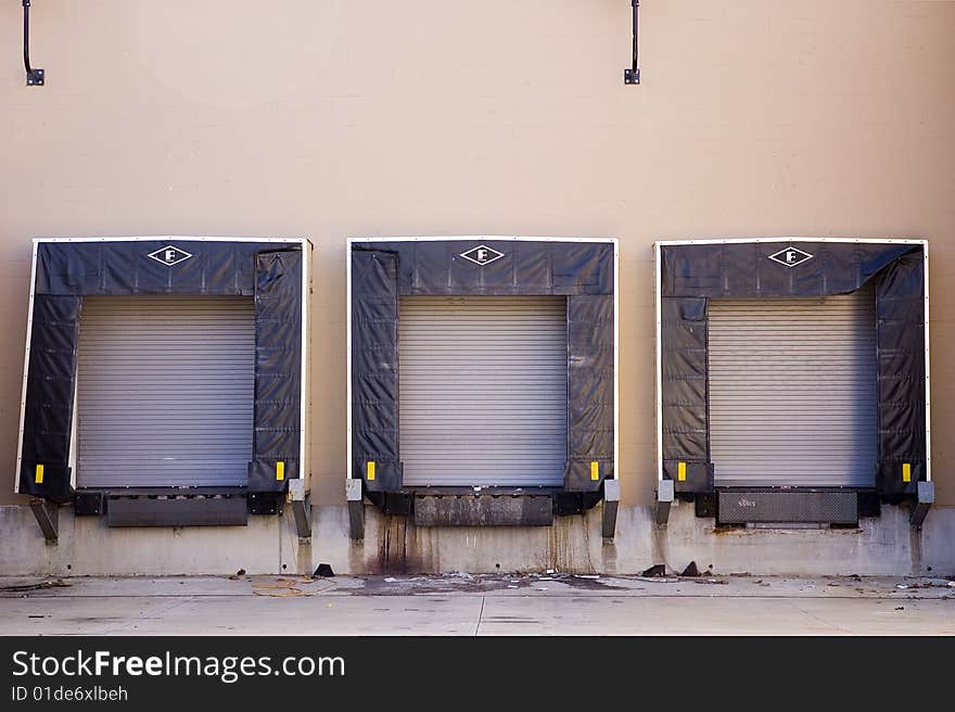 Three empty shipping bays in the back of a  building.