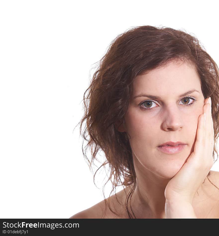 A young beautiful woman with her hand on her face. A young beautiful woman with her hand on her face.