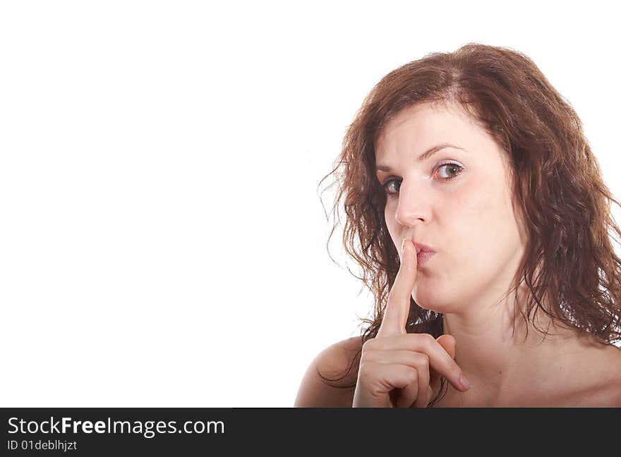 A young beautiful woman with a finger over her lips. Isolated over white with a lot of copy space. A young beautiful woman with a finger over her lips. Isolated over white with a lot of copy space.