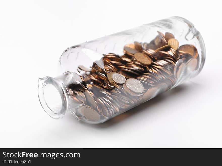 Glass bottle full of coins