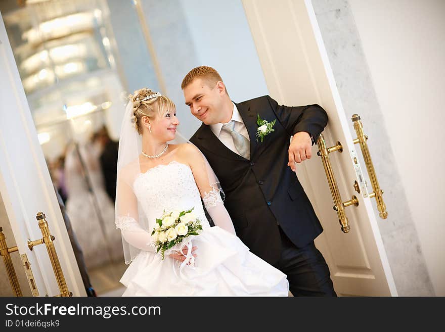 Bride and groom at the opened doors. Bride and groom at the opened doors