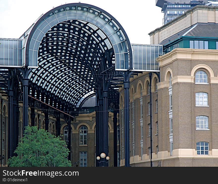 An older business office with a new and modern glass roof next to it. An older business office with a new and modern glass roof next to it.