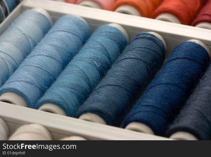 Colorful spools of thread in a box