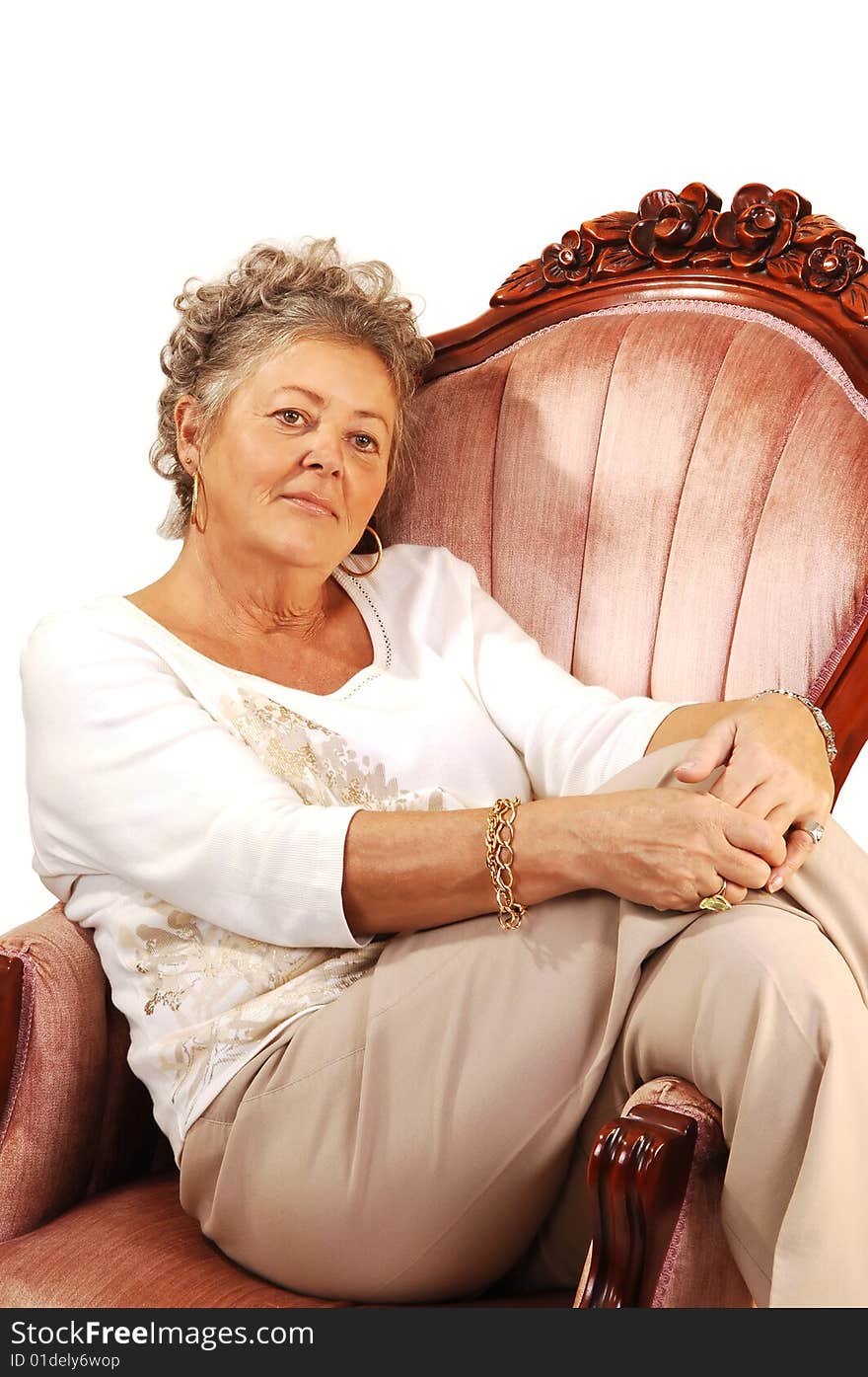 An nice senior woman relaxing in an pink armchair and just dreaming into
the day. Wearing beige trousers and a white sweater. An nice senior woman relaxing in an pink armchair and just dreaming into
the day. Wearing beige trousers and a white sweater.