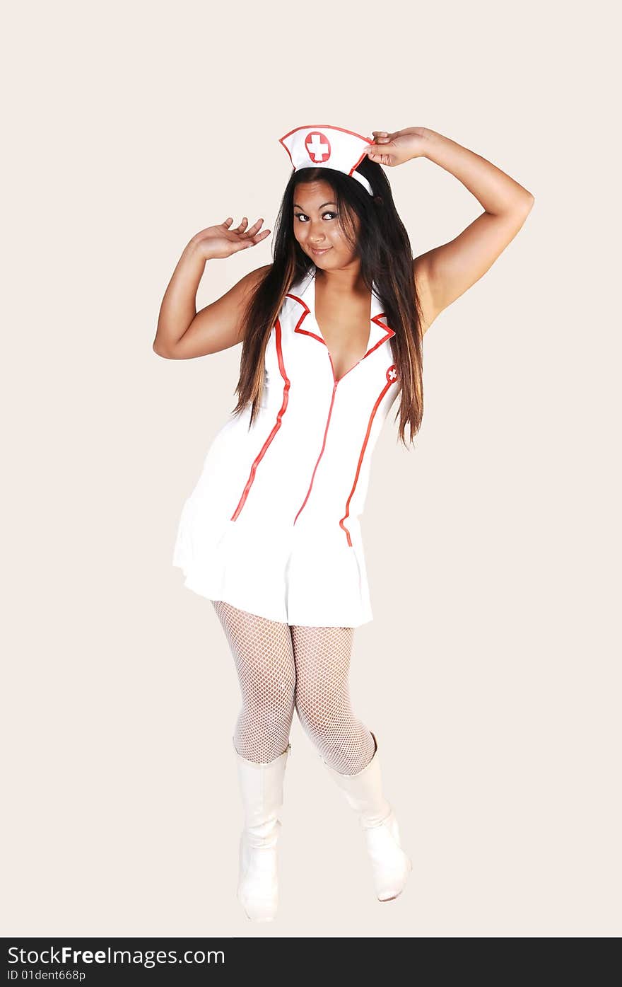 Young Asian woman with long black hair and white fish net stockings
and boots in a nurse uniform on light gray background. Young Asian woman with long black hair and white fish net stockings
and boots in a nurse uniform on light gray background.