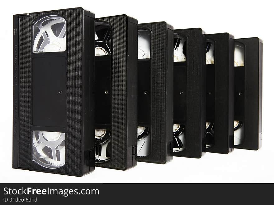 Several black VHS video cassettes on white background. Several black VHS video cassettes on white background