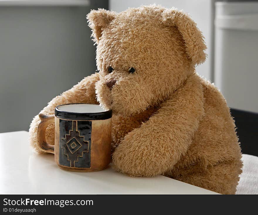 Teddy bear with an empty cup. Teddy bear with an empty cup