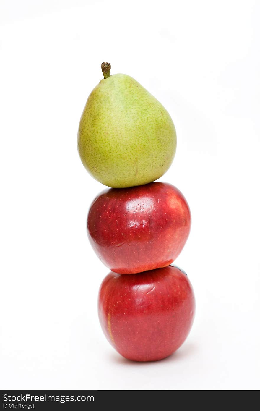 Two apples and a pear stacked on white background. Two apples and a pear stacked on white background.