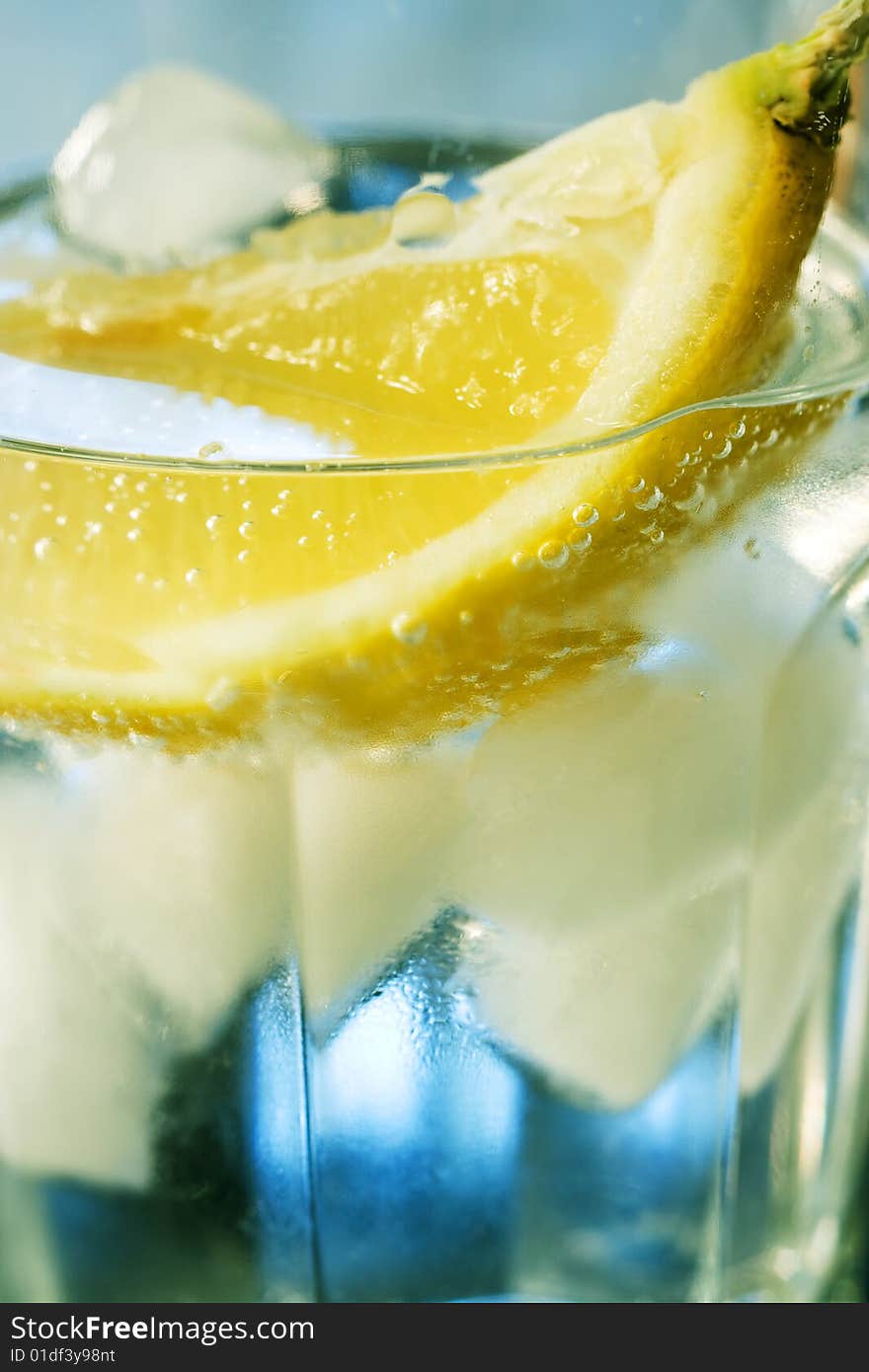 Close-up of Water glass with lemon and ice