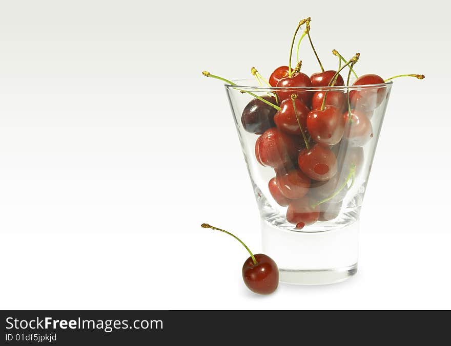 Cherry in glass on white background