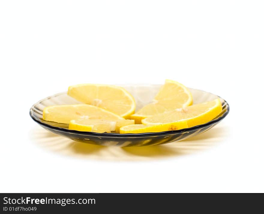 Lemon slices on plate isolated on white