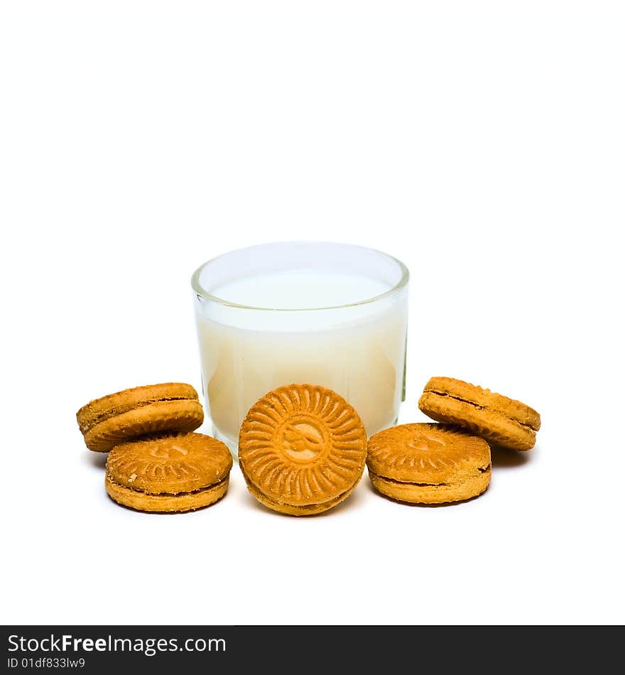 Glass with milk and cakes isolated on white