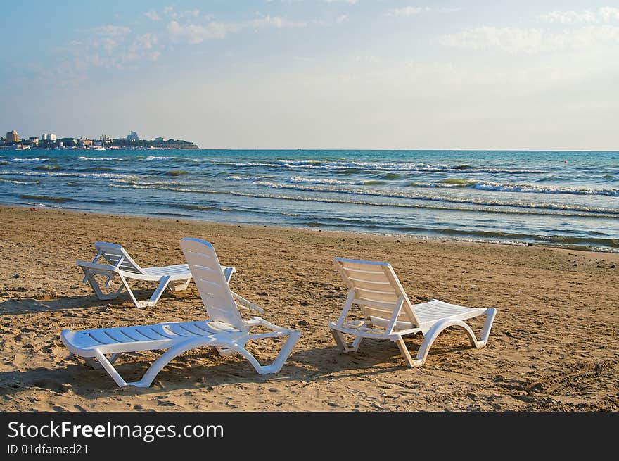 Three empty chaise-longue