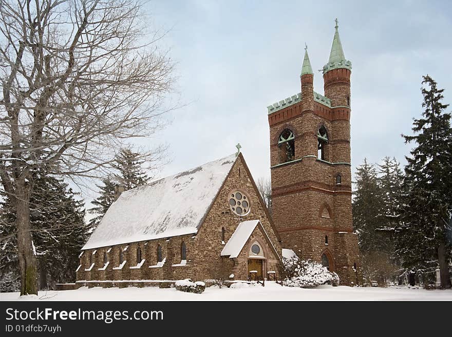 The exterior of a beautiful stone church after a fresh snow. The exterior of a beautiful stone church after a fresh snow.