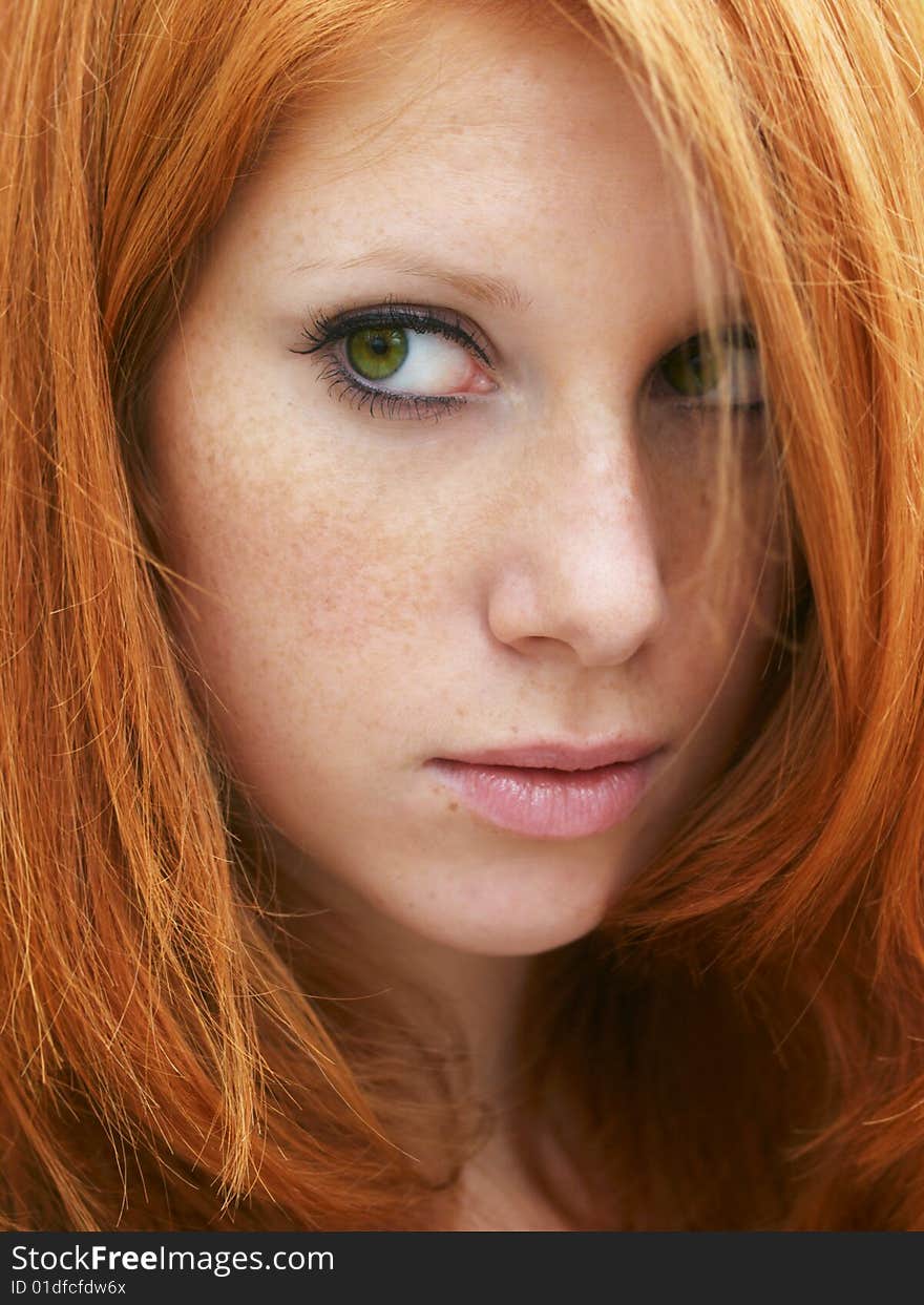 Sensual portrait of beautiful girl with long red hair